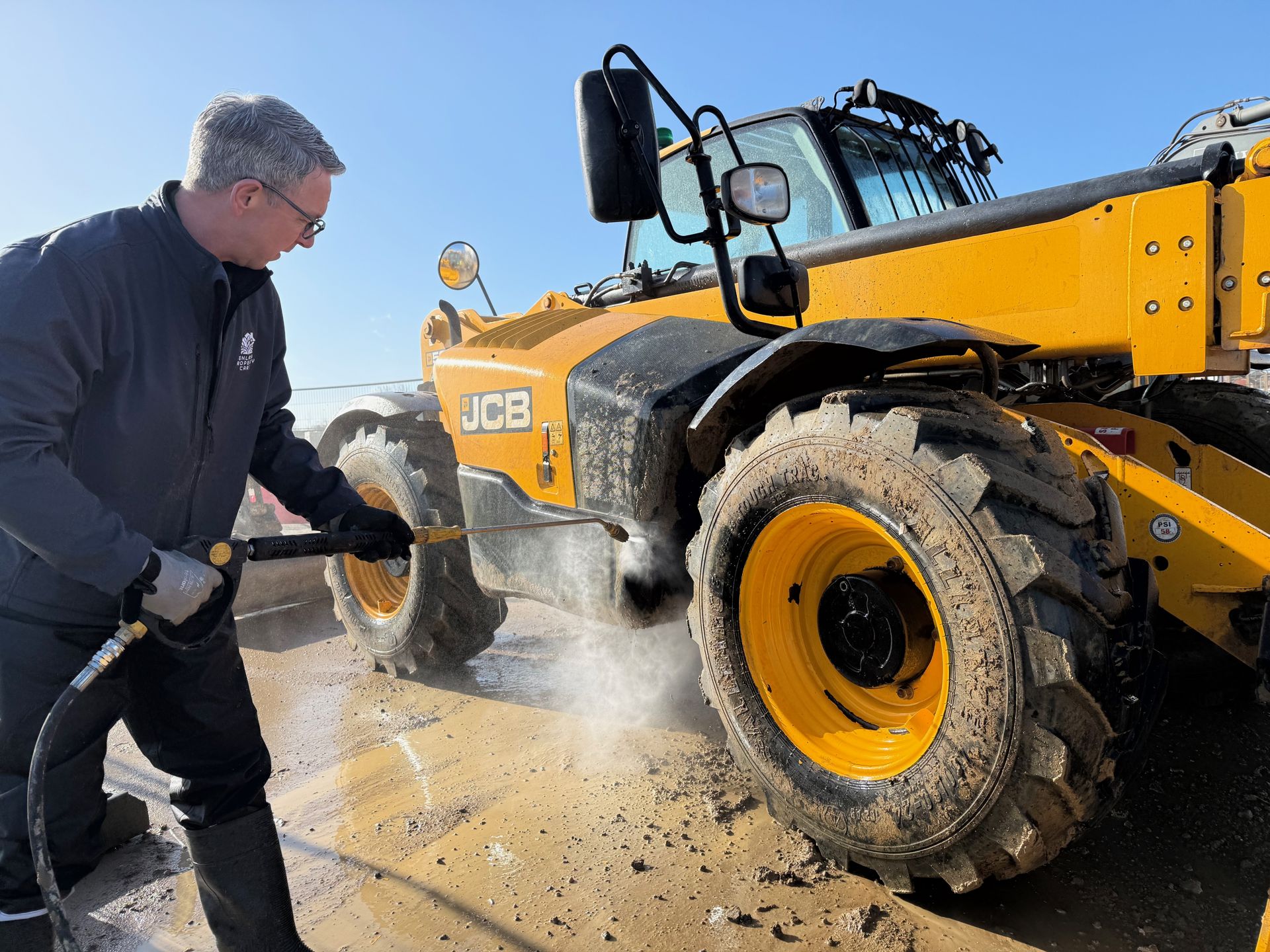 Paul from Fenland Property Care pressure washing a JCB telehandler in Lincolnshire